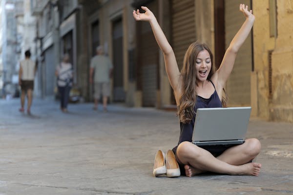 small business success woman with hands in air
